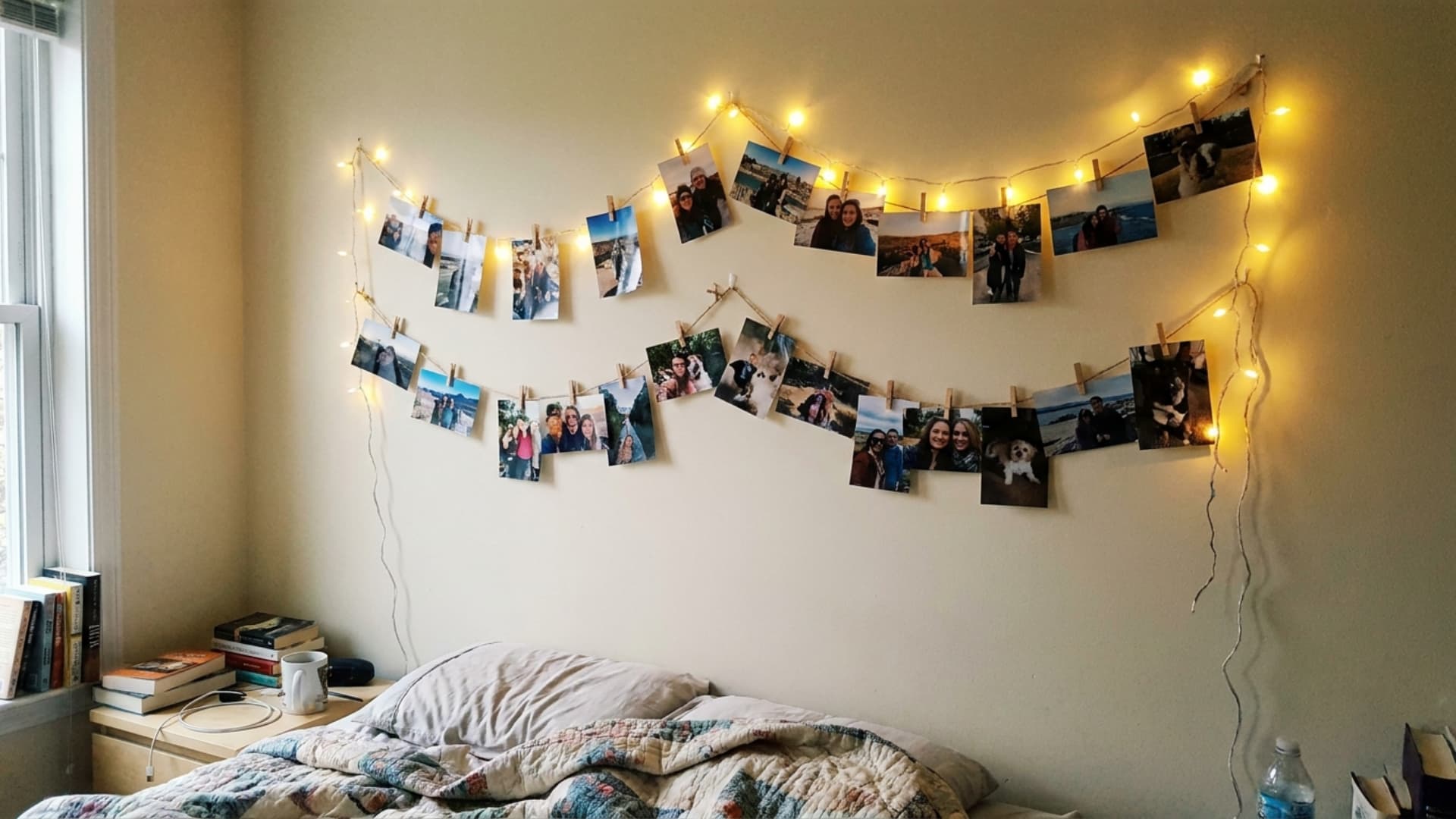 string lights photo display with printed pictures clipped along fairy lights on bedroom wall