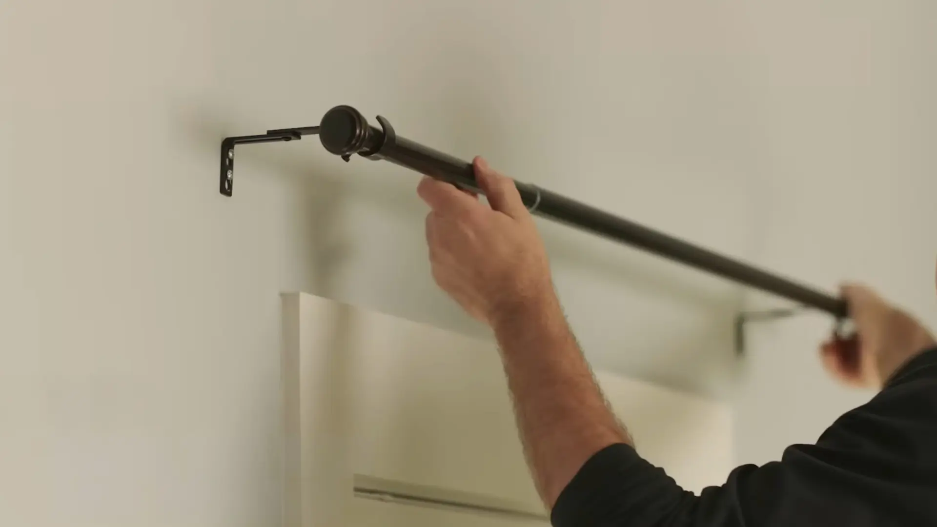 sliding curtain rod finial into wall mounted bracket above window