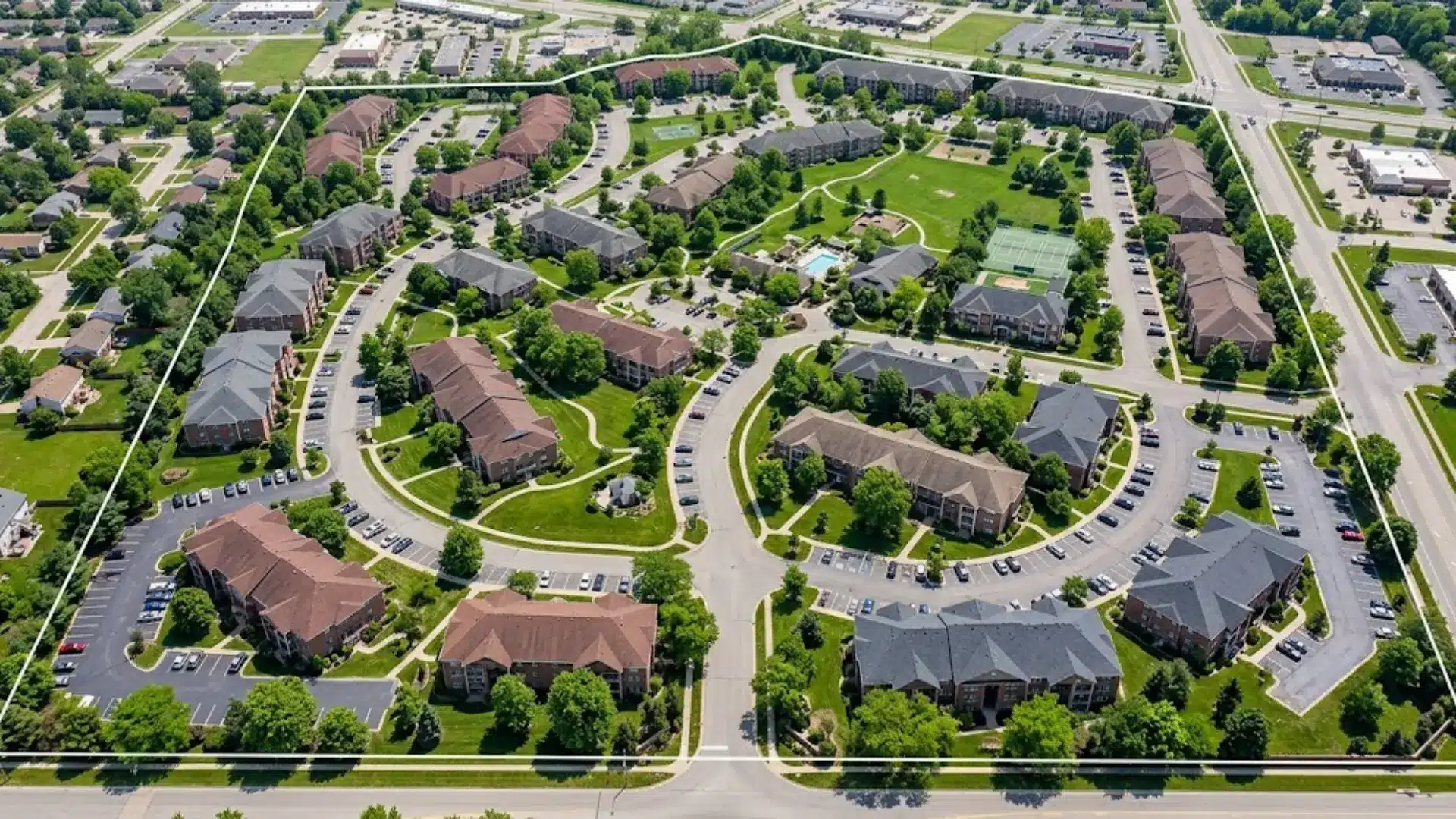 aerial view of garden style apartment complex outlined in white showing campus layout