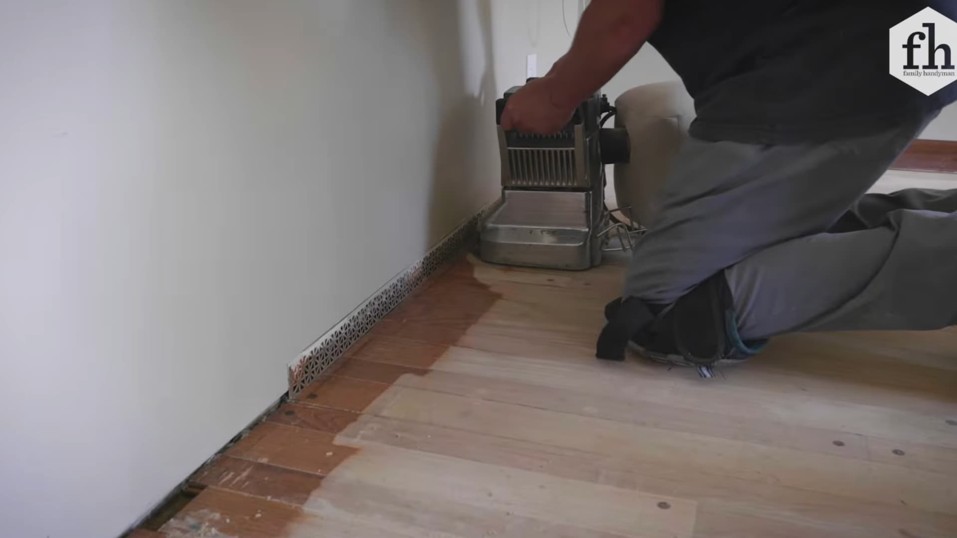 edging sander removing old finish along hardwood floor baseboard