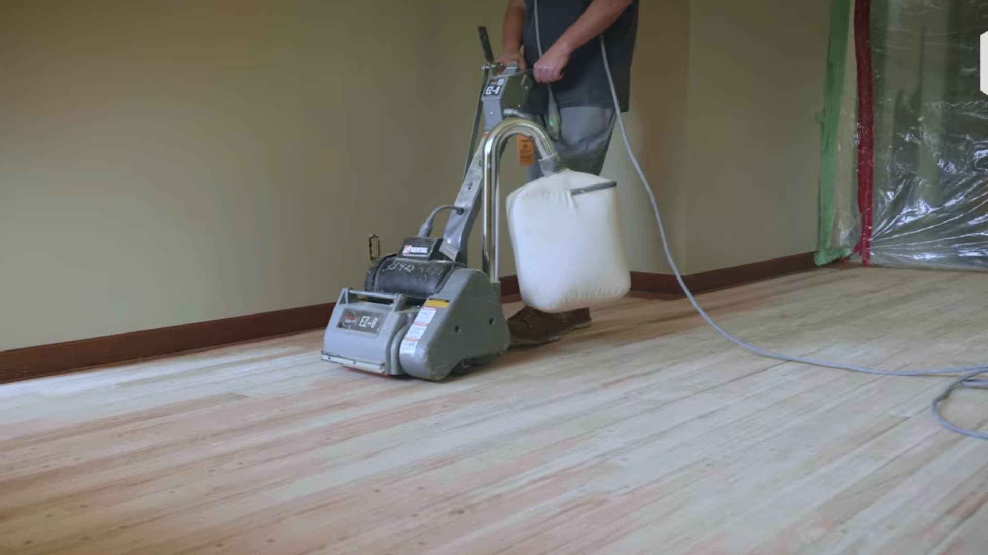 drum sander being used to sand main hardwood floor area during refinishing