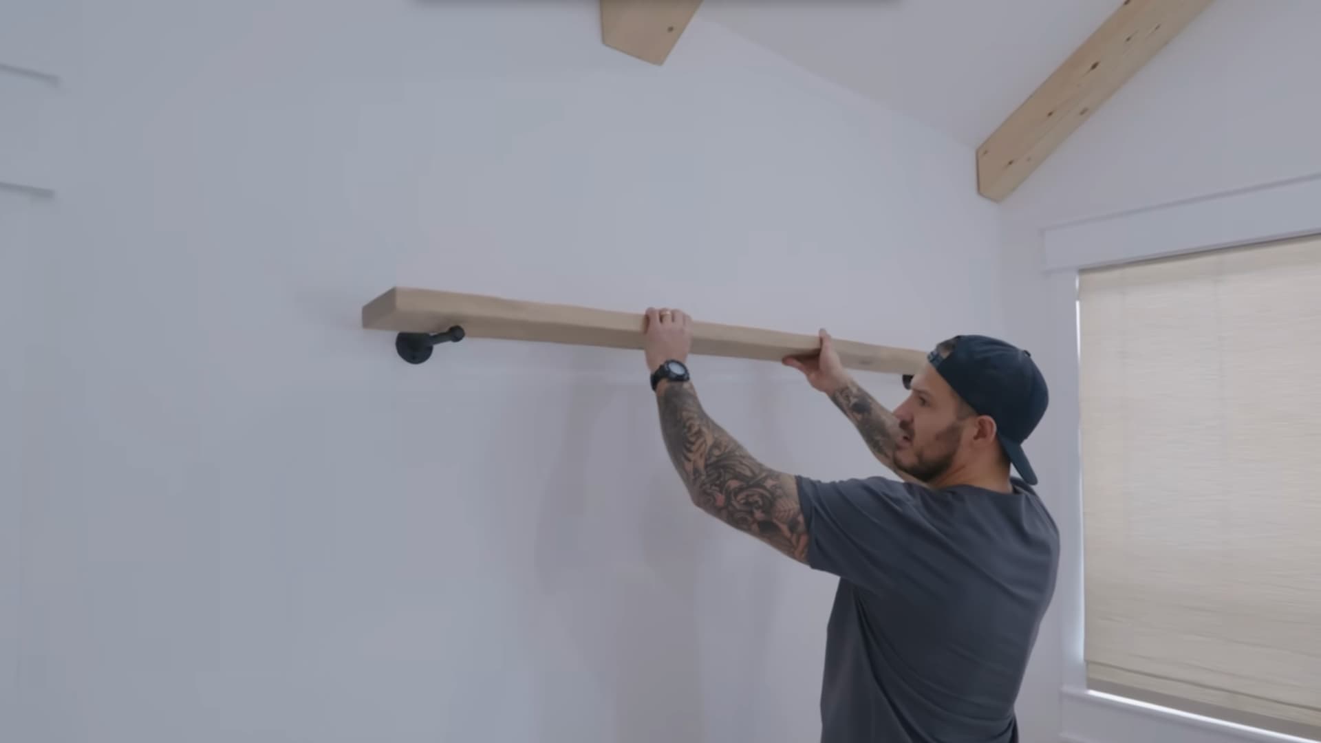 sliding a finished floating shelf box onto a wall mounted cleat