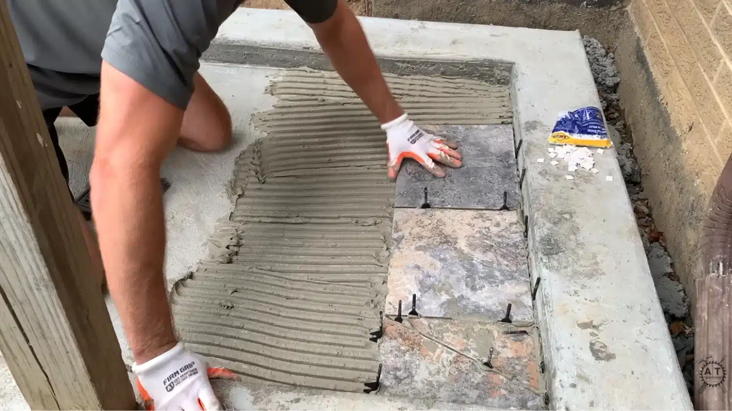 applying thinset mortar and setting large format tile inside a concrete shower pan