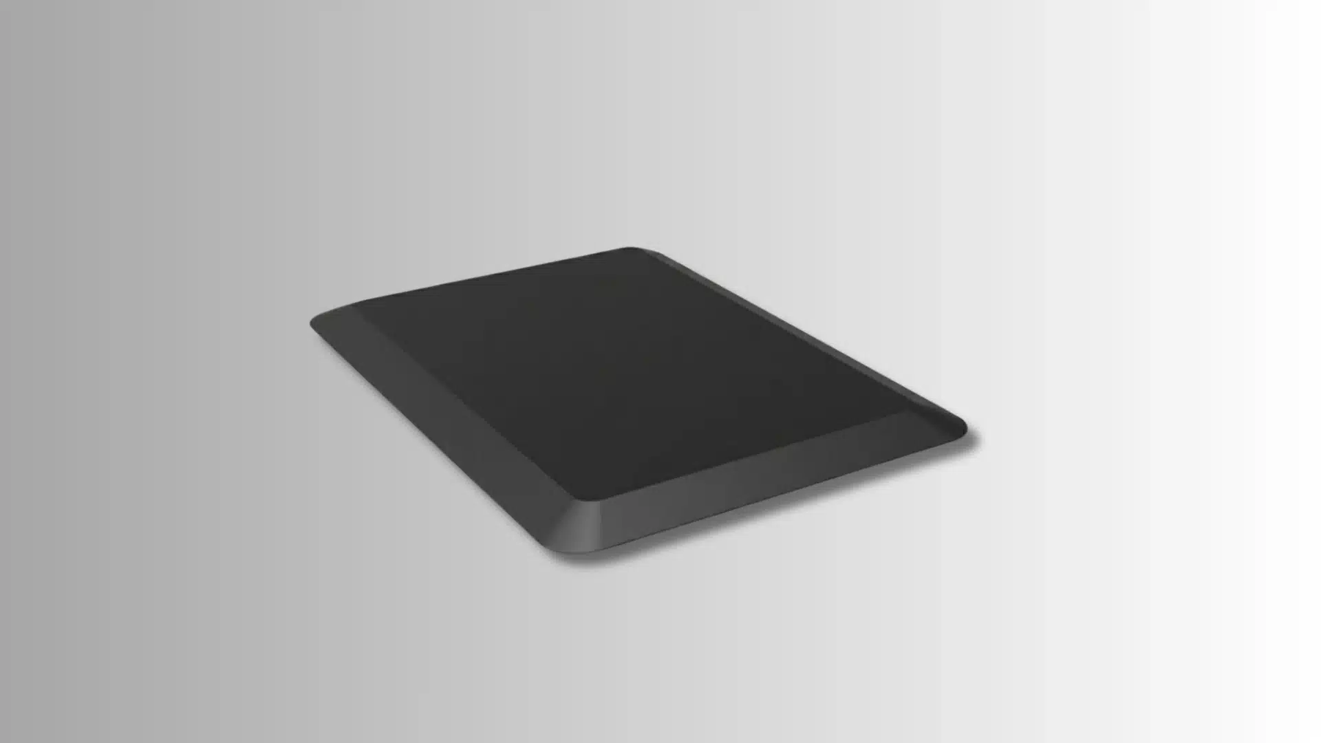 black rectangular anti-fatigue mat with raised edges on a white background