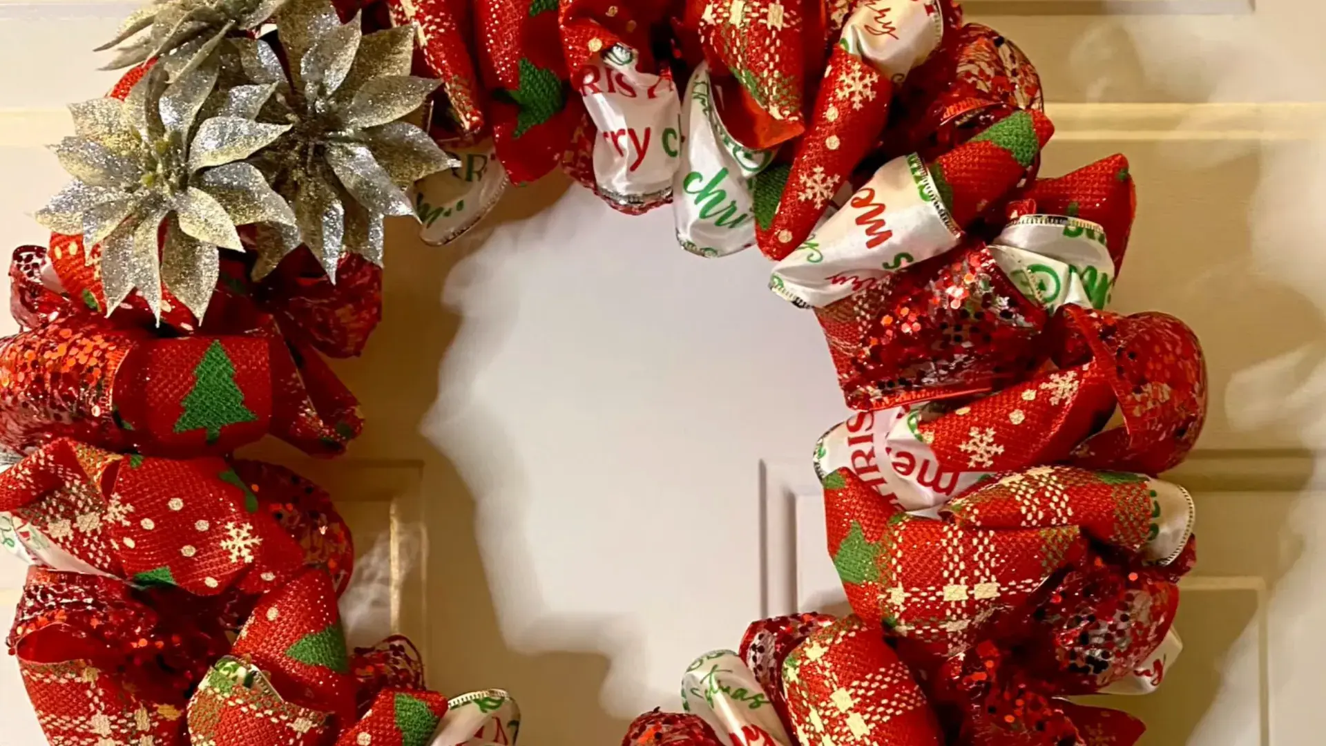 christmas ribbon loops fluffed and finished with a cluster of decorative silver flowers