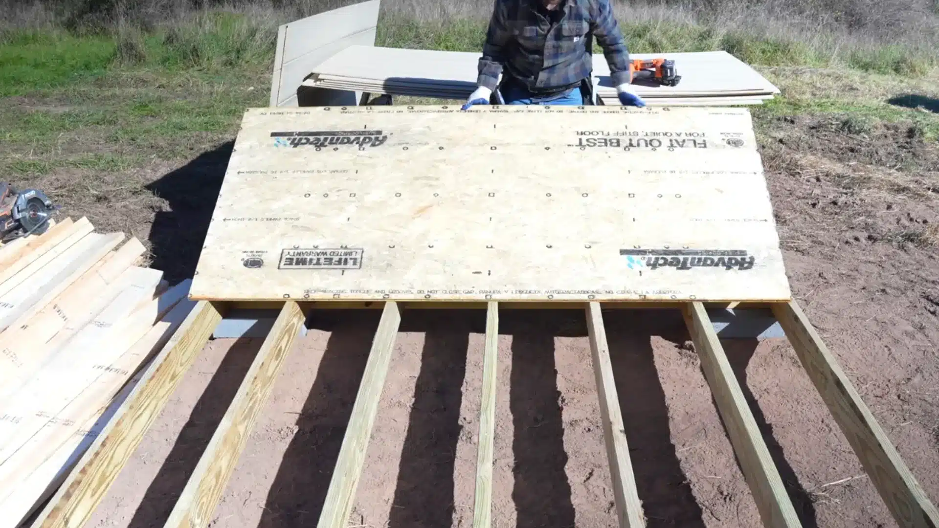 floor construction with joists and plywood installed on leveled foundation outside