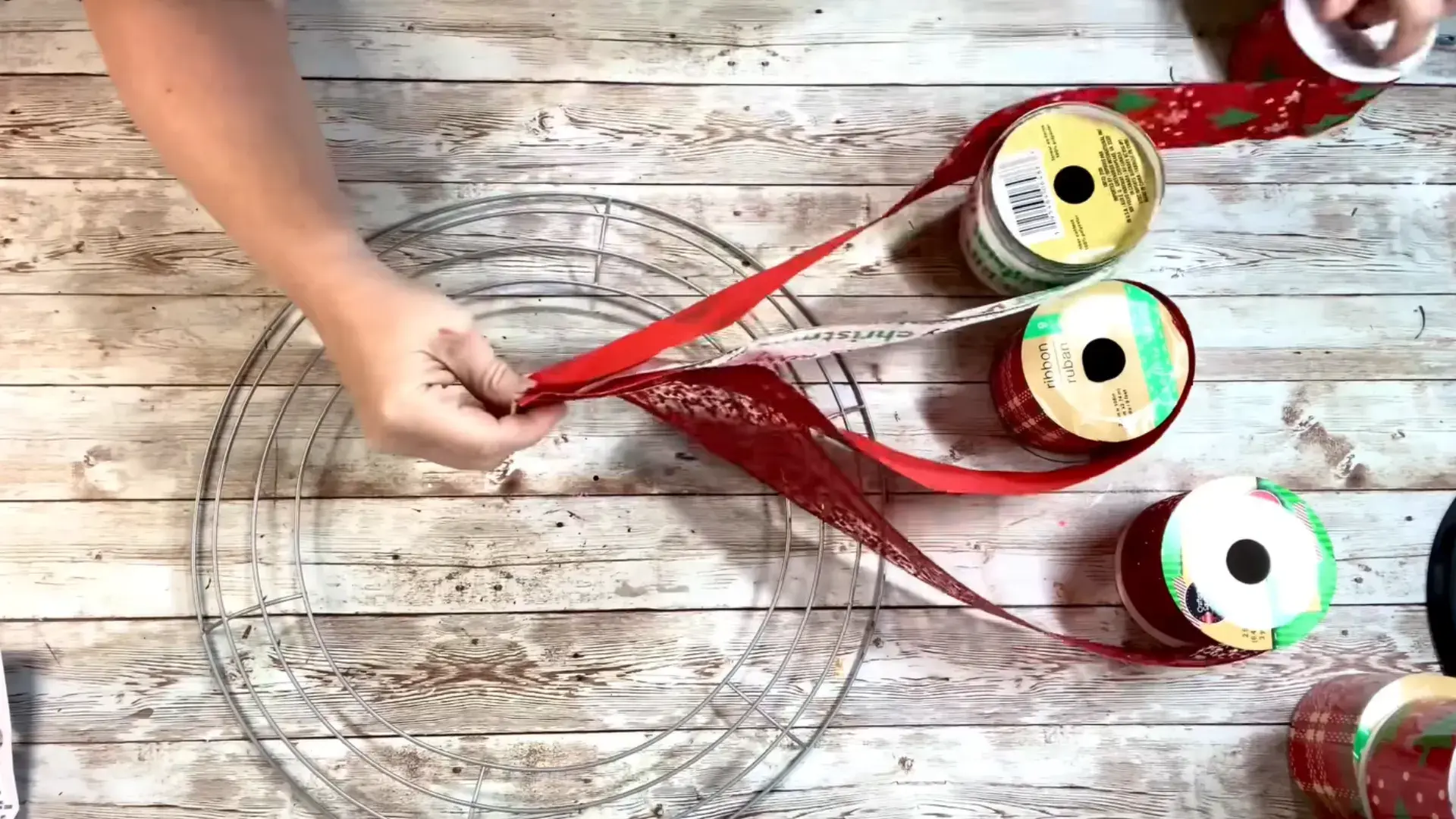 four christmas ribbon patterns stacked together before attaching them to the wreath frame
