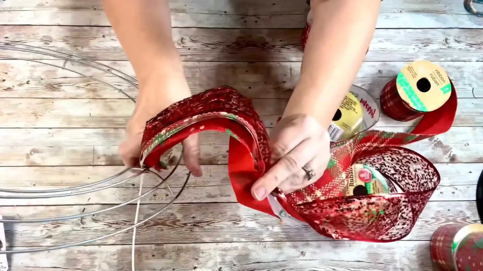 layered christmas ribbons formed into even loops and secured with zip ties on a wreath frame
