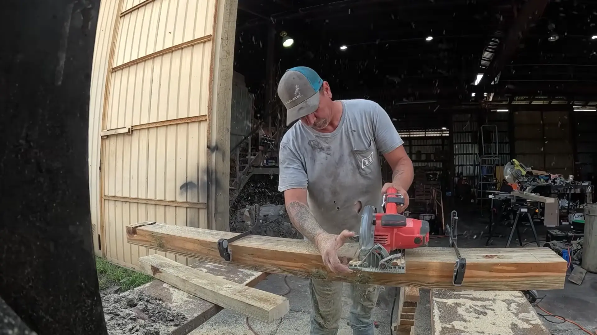 man using a circular saw to cut notches in clamped 4x4 lumber for a diy chicken coop frame