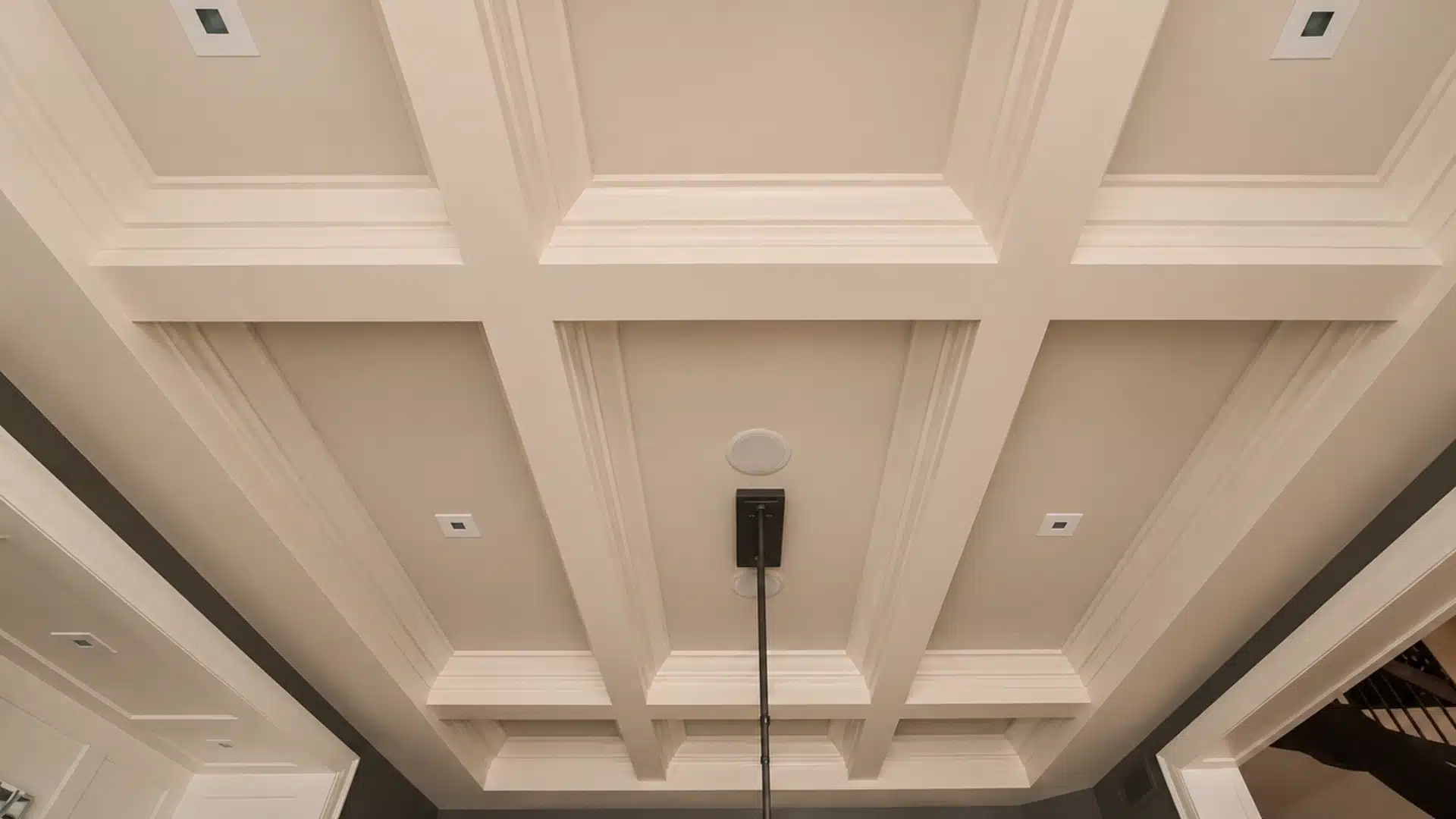 narrow room featuring elongated rectangular coffered ceiling panels