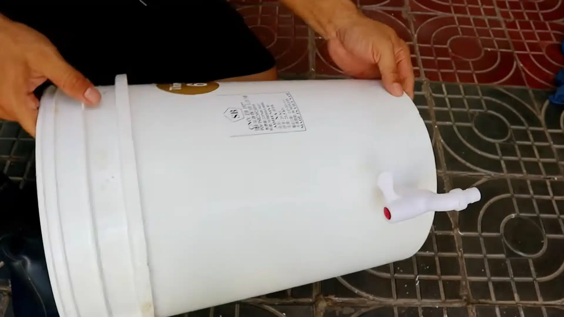 person preparing a white bucket for a simple home composting setup