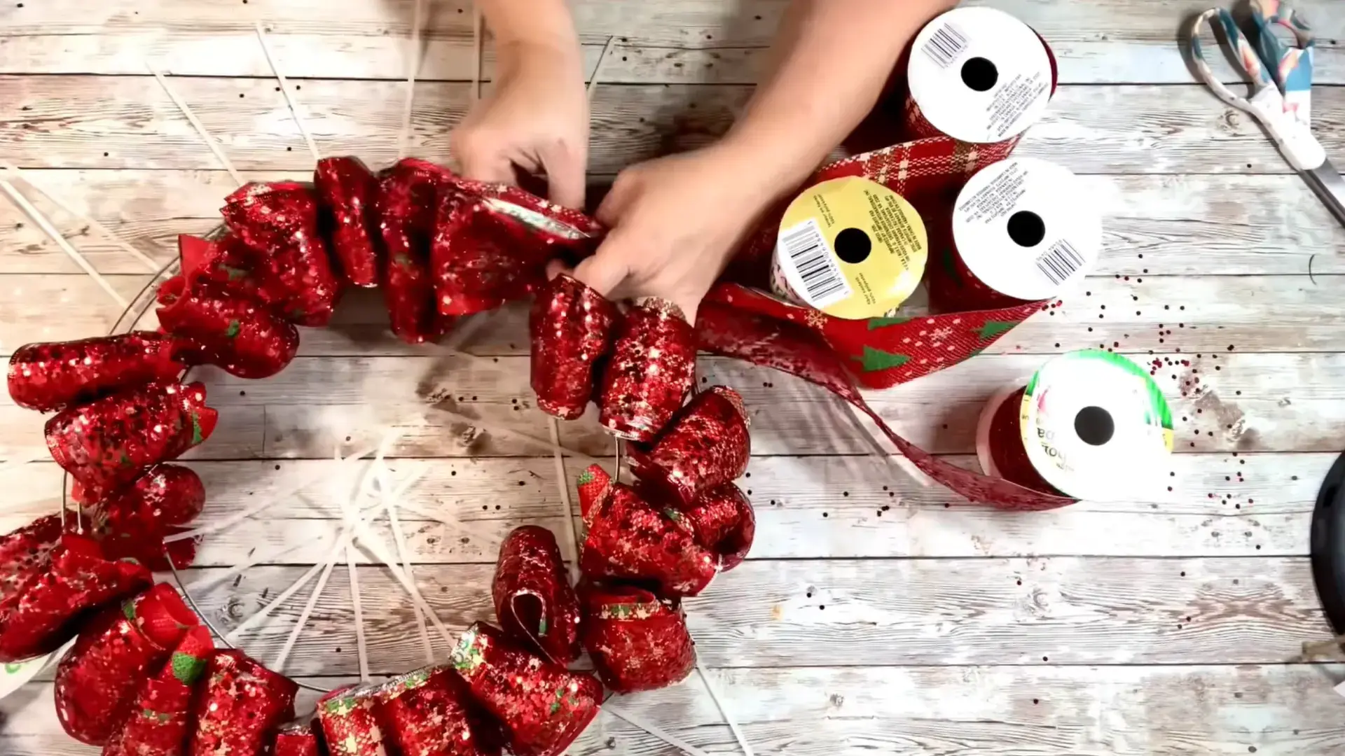 ribbon loops covering the wreath frame as the layered pattern continues around each section