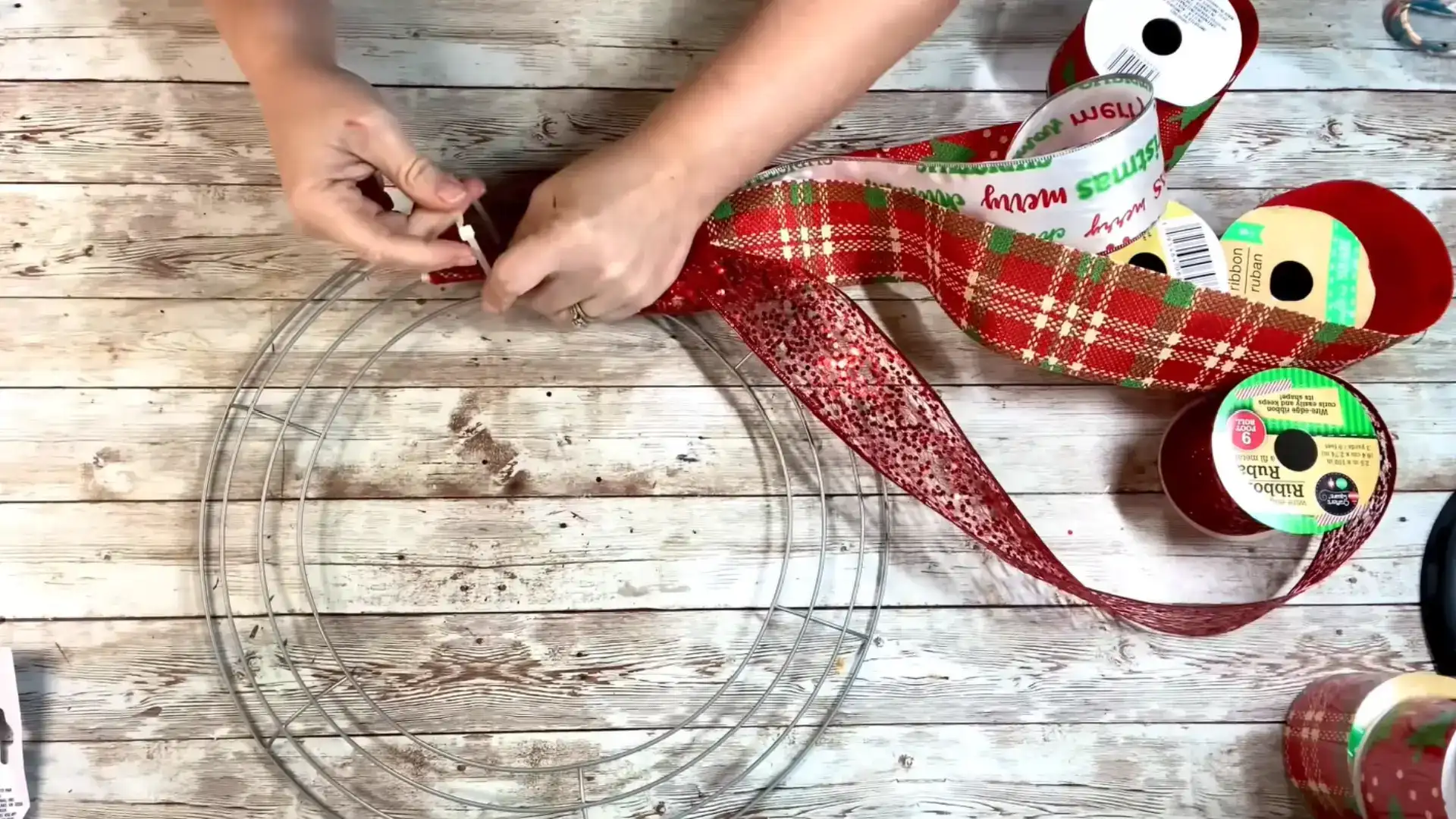 stacked ribbon ends secured with a zip tie to the second ring of the wreath frame