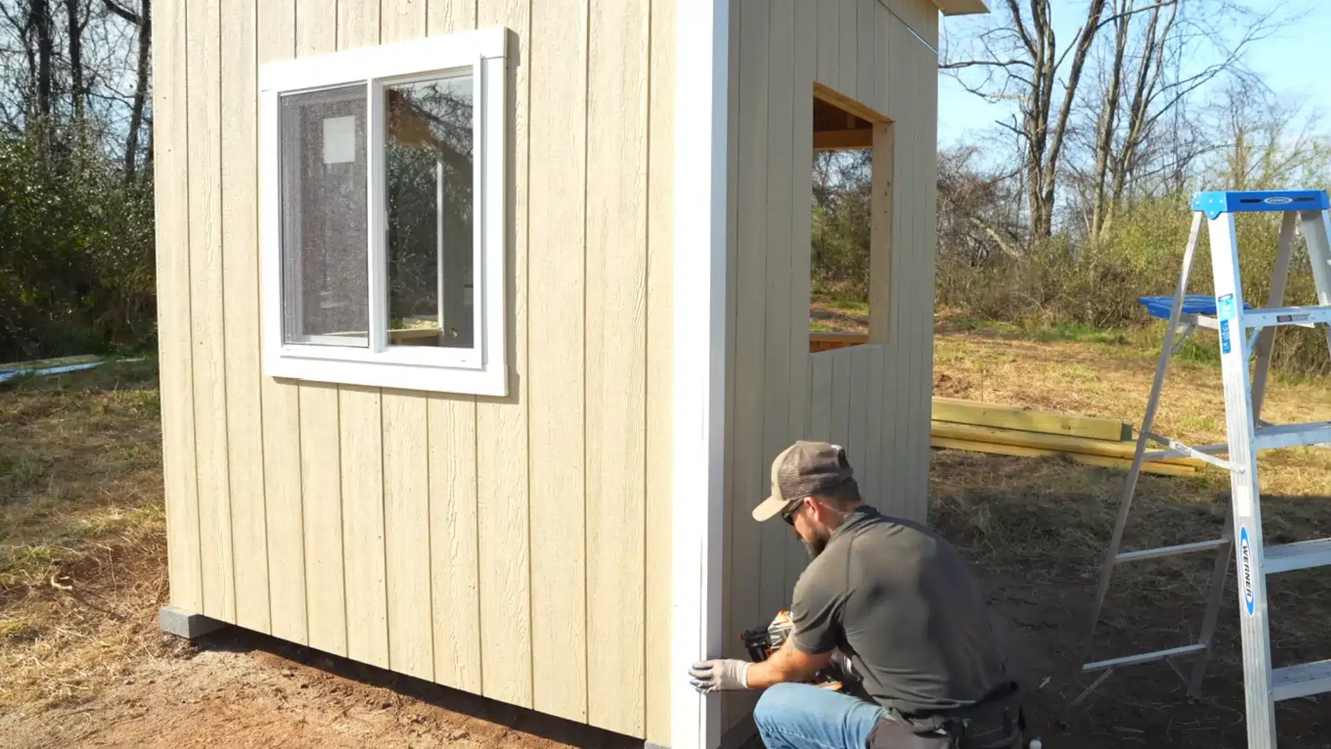trim installation along window and corner edges being nailed into place