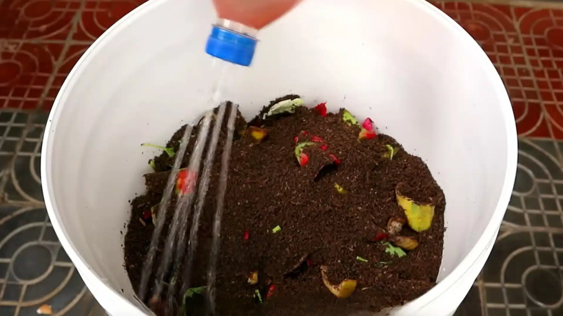 water being added to a compost mixture to maintain proper moisture levels