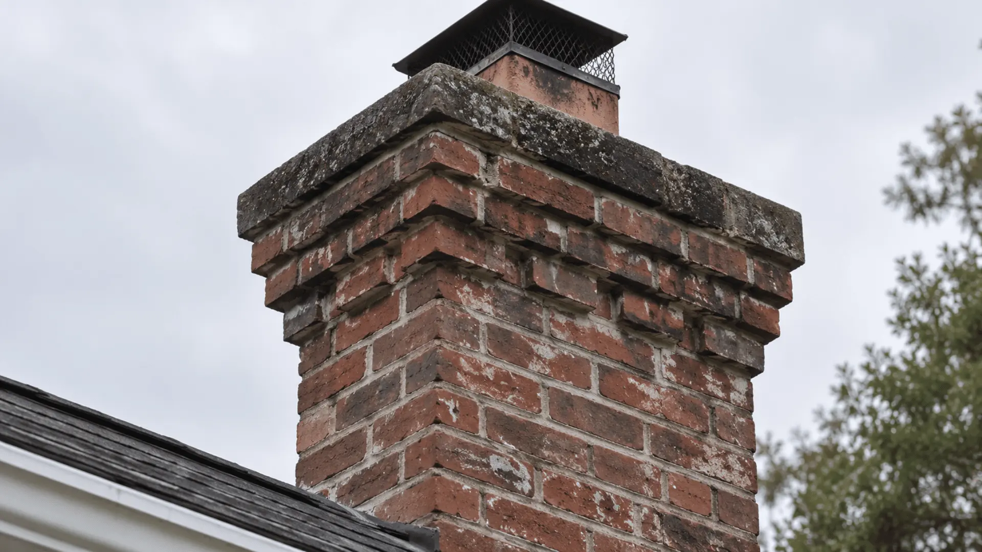 close-up of decorative brick corbelling near the top of a colonial chimney