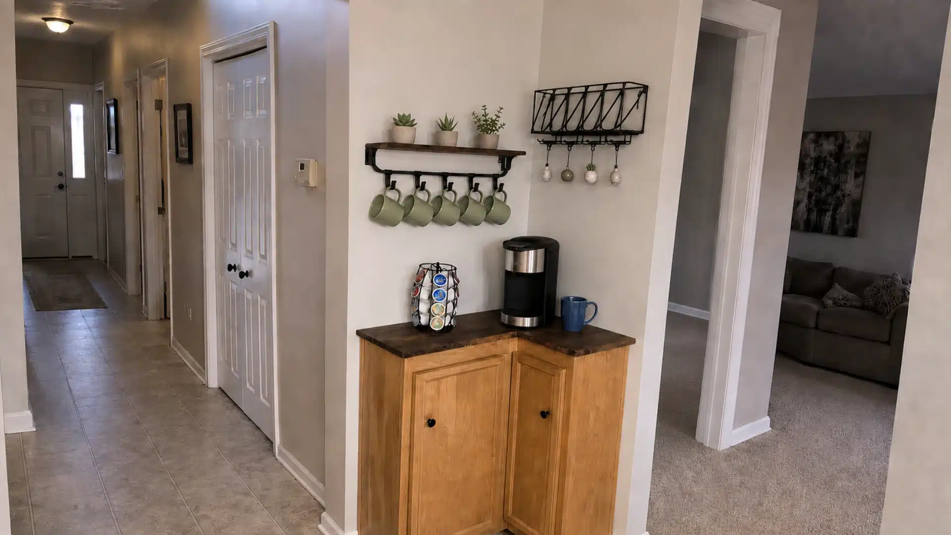 corner coffee cabinet with wood counter mug rack hanging cups keurig machine and small potted plants on shelf