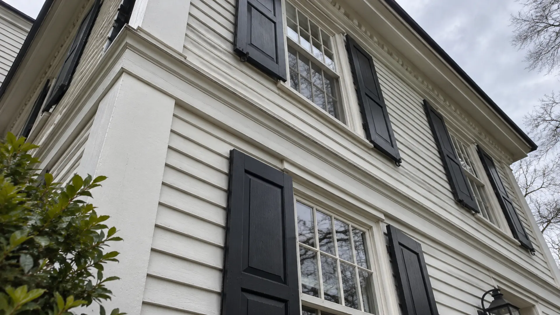 low angle view of a colonial home showing trim between first and second floor windows
