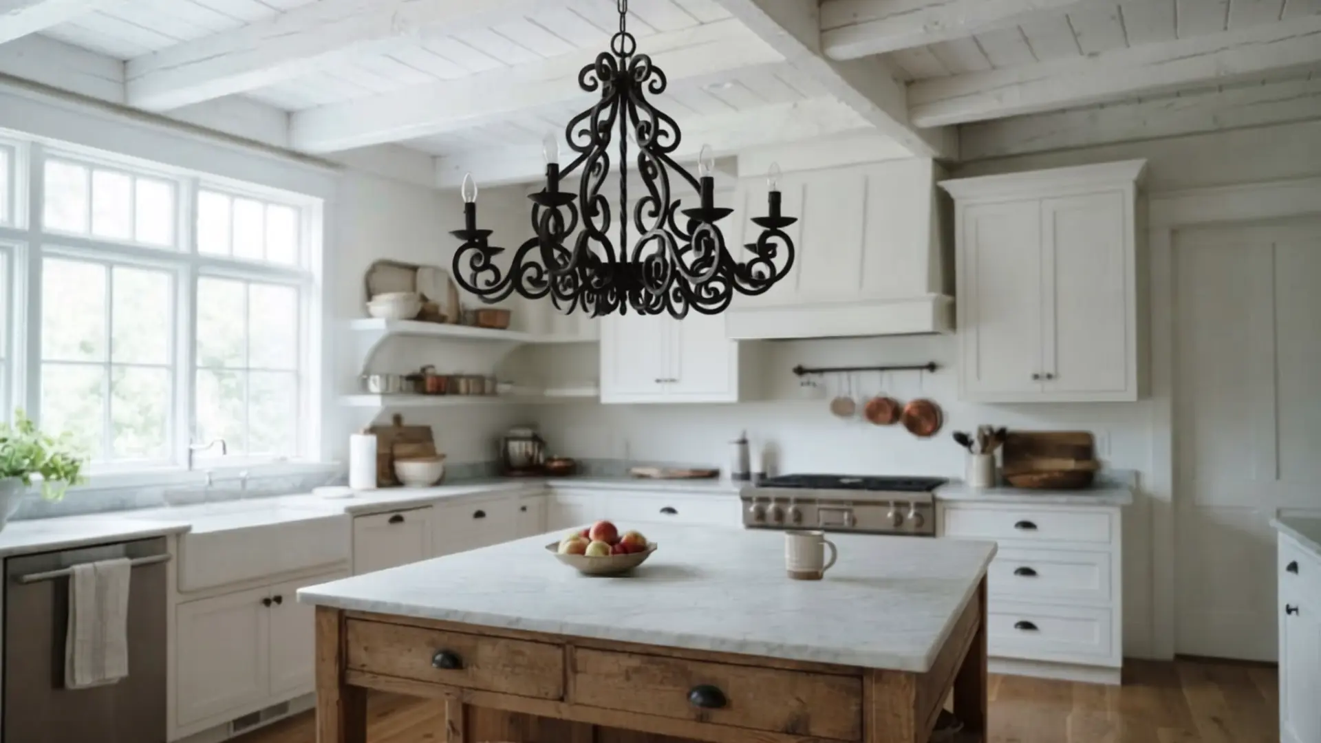 black wrought iron chandelier with candle style bulbs above a farmhouse kitchen island